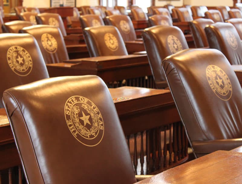 Empty seats in the Texas House chamber.